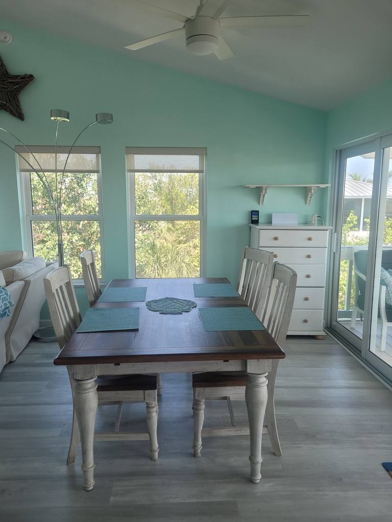 Dining table set for six with teal placemats