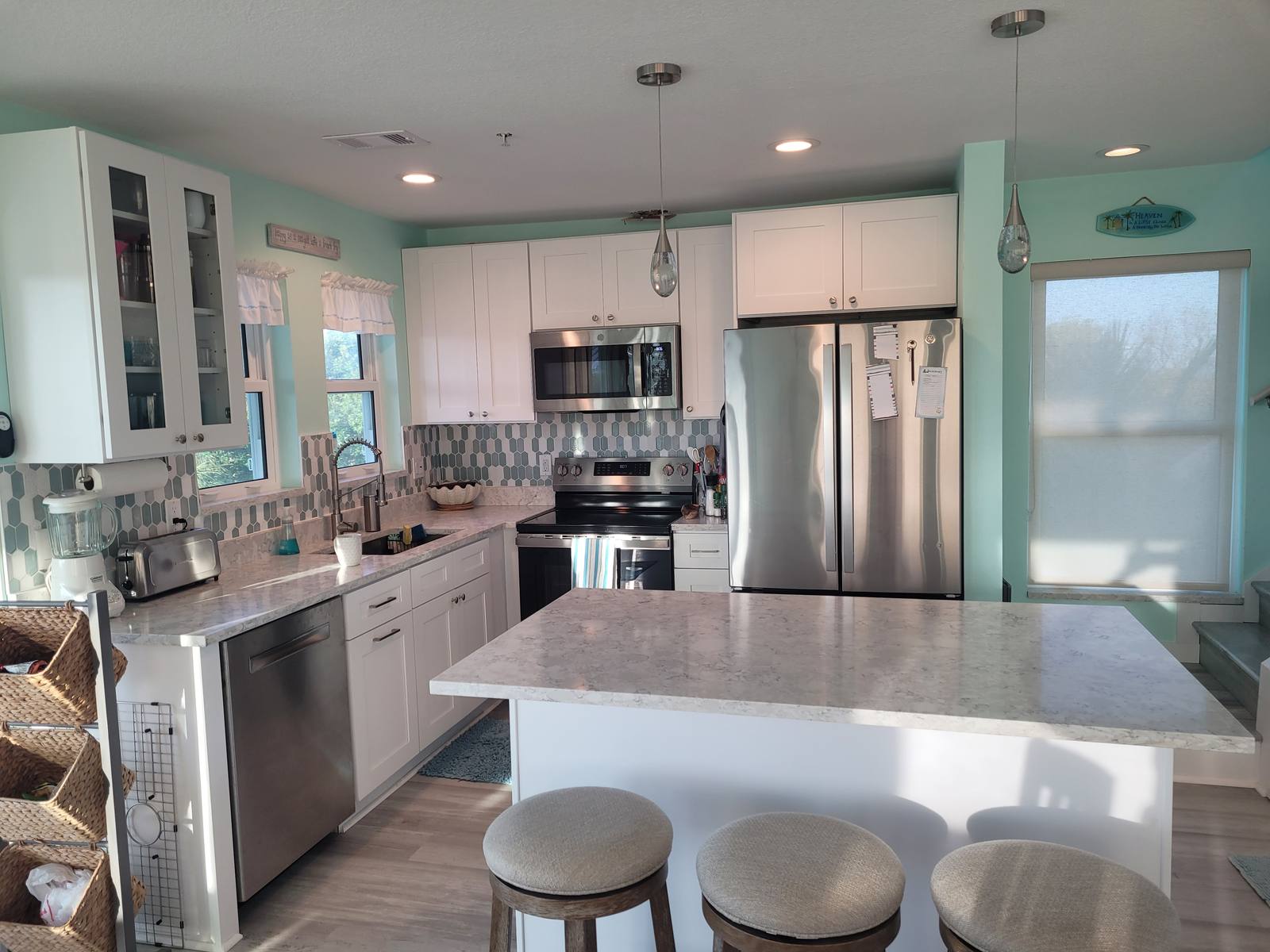 Fully remodeled kitchen with white cabinets and a tile backsplash