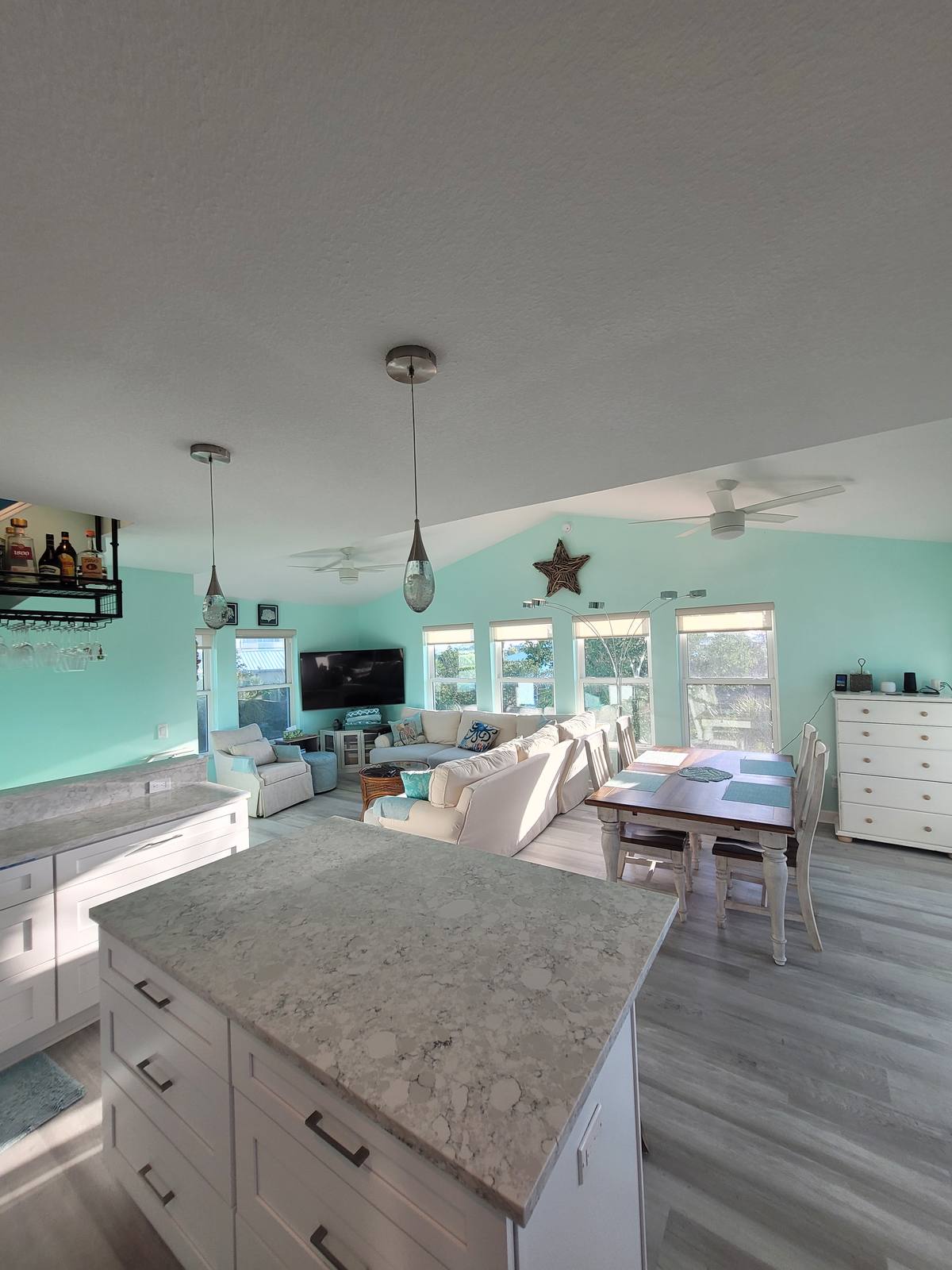 Open-concept living, dining, and kitchen area with a large sectional and dining table