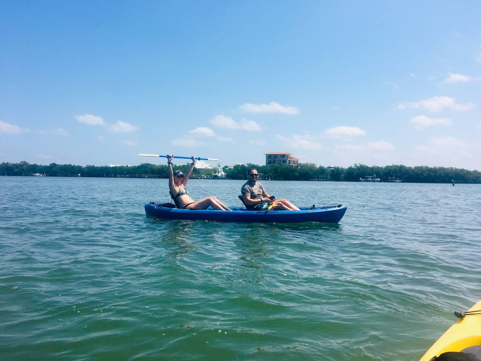 Two guests on a tandem kayak on the water near North Captiva